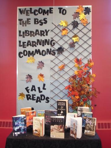 Bulletin board for fall that says Welcome to the BSS Library Learning Commons, with a display of books on a table